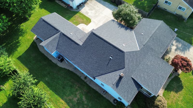 Aerial view of gray shingle roof on blue house