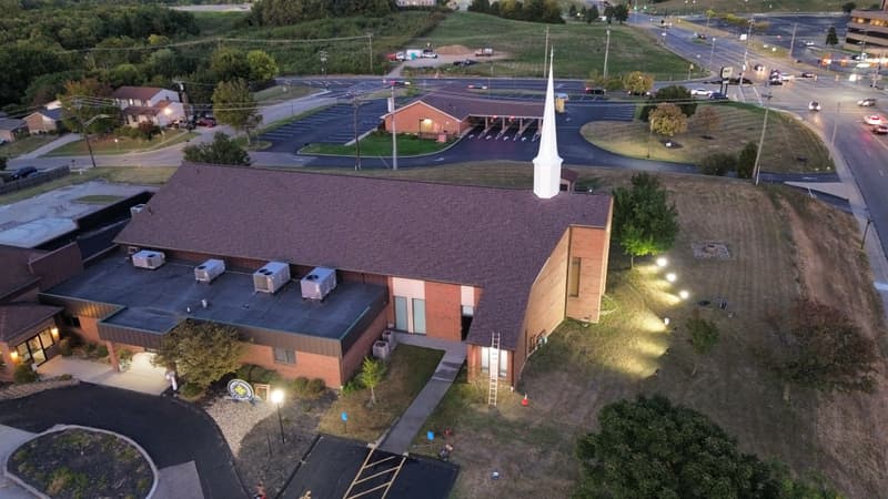 Aerial view of church building at dusk with roof