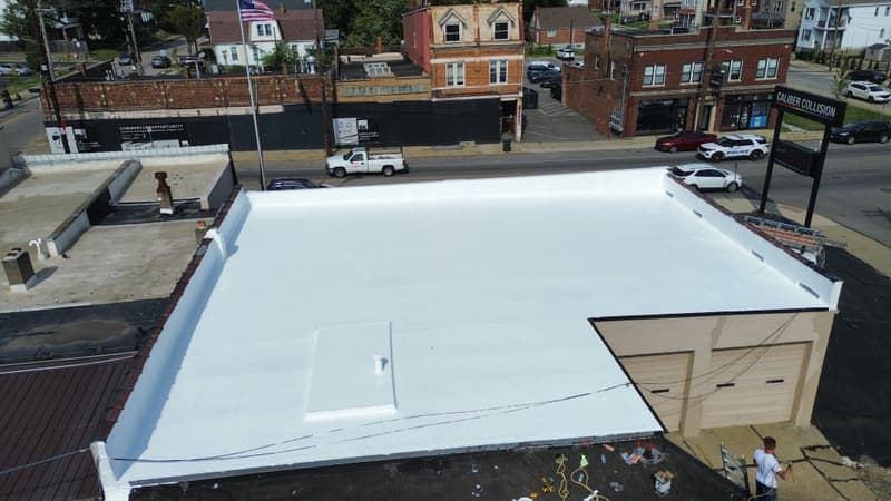 Aerial view of white coated flat roof on commercial building