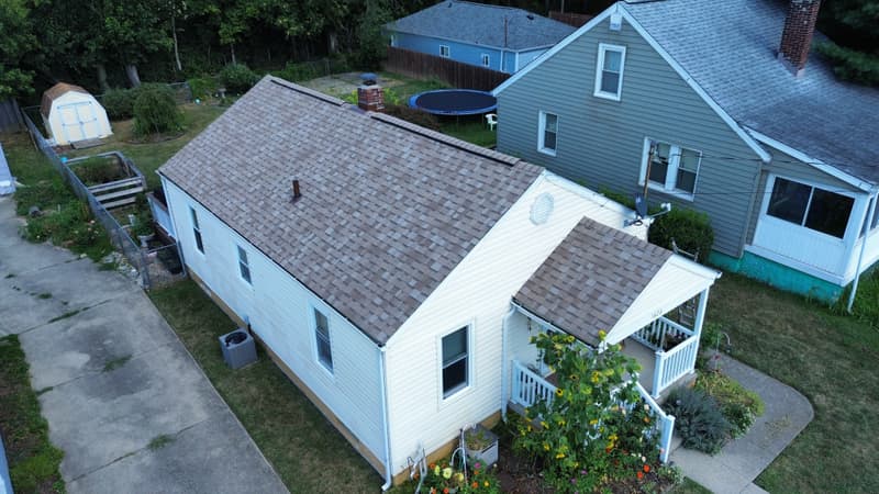 Aerial view of house with new brown shingle roof